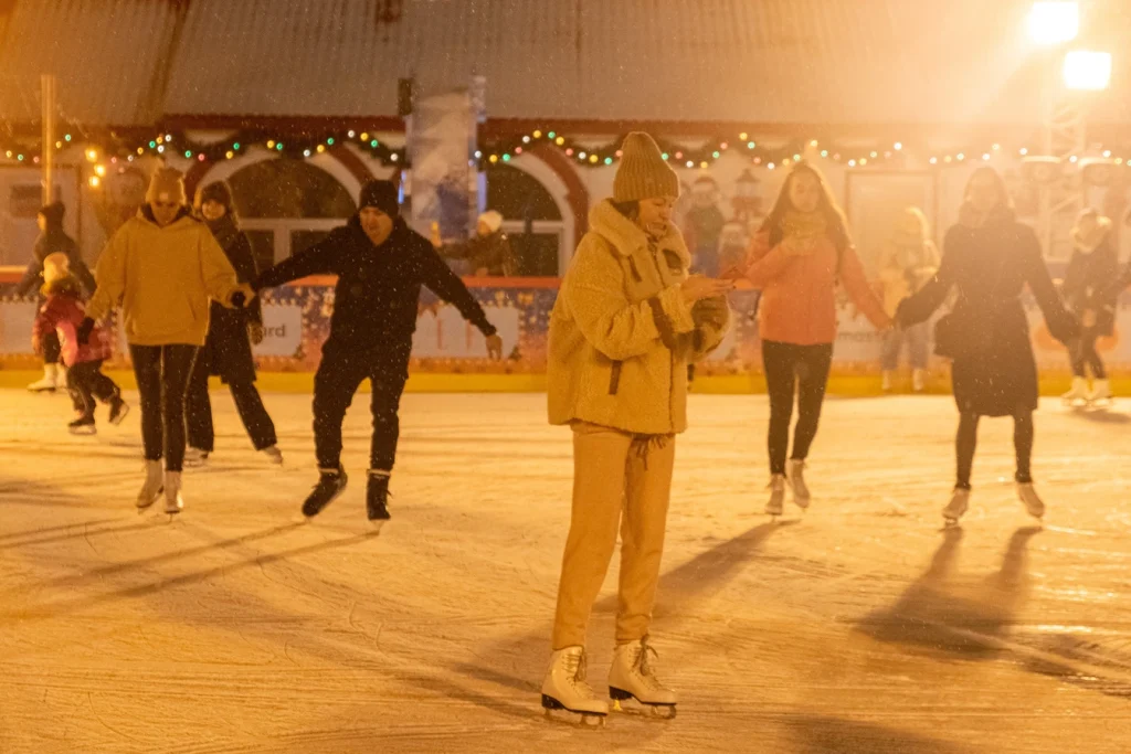 People ice skating at night
